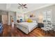 Spacious main bedroom with hardwood floors, tray ceiling, plantation shutters, and en-suite bathroom access at 1655 Pinyon Pine Dr, Sarasota, FL 34240