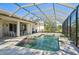 Screened-in pool surrounded by an expansive patio area and backyard at 1655 Pinyon Pine Dr, Sarasota, FL 34240