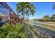 Water view of canal from lush backyard with tropical foliage and mature palms at 1655 Pinyon Pine Dr, Sarasota, FL 34240