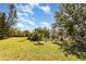 Expansive backyard with mature trees and lush landscaping, perfect for outdoor activities at 1730 Hudson St, Englewood, FL 34223