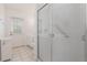 Well-lit bathroom featuring a walk-in shower and white cabinets at 1730 Hudson St, Englewood, FL 34223