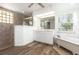 Elegant bathroom with a separate shower, soaking tub, and a spacious vanity at 1730 Hudson St, Englewood, FL 34223