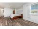 Bright bedroom features a ceiling fan, wood floors, and a large window at 1730 Hudson St, Englewood, FL 34223