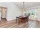 Inviting dining room with wood-look floors, large window, and stylish chandelier at 1730 Hudson St, Englewood, FL 34223