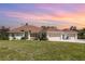 Charming single-Gathering home featuring a well-manicured lawn, three-car garage and inviting facade at 1730 Hudson St, Englewood, FL 34223