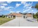 Charming single-story home featuring a three-car garage and well-manicured lawn at 1730 Hudson St, Englewood, FL 34223