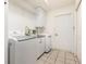 Functional laundry room featuring modern washer and dryer units, and ample cabinet space at 1730 Hudson St, Englewood, FL 34223