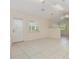 Bright living room features white tile floors and multiple large windows at 1730 Hudson St, Englewood, FL 34223