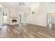 A bright living room features hardwood flooring and a stone fireplace at 1730 Hudson St, Englewood, FL 34223