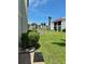 Exterior view of community buildings with pond, lush grass, and mature palm trees at 1801 Gulf N Dr # 184, Bradenton Beach, FL 34217