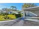This single-story home has a covered carport and nicely manicured landscaping at 1832 University Pl # 23, Sarasota, FL 34235
