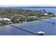 Aerial view of waterfront home near bridge, showcasing a pier and serene waters at 2212 6Th W St, Palmetto, FL 34221