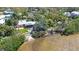 Aerial view of waterfront home with sandy beach and lush landscaping at 2212 6Th W St, Palmetto, FL 34221