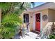 Charming front entrance with a bright red door and decorative accents at 2212 6Th W St, Palmetto, FL 34221