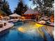 Resort-style pool featuring a tiki bar, umbrella, and inviting lighting at 2212 6Th W St, Palmetto, FL 34221