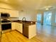 Open kitchen with stainless steel appliances, wood floors and access to the living area at 2543 River Preserve Ct # 2543, Bradenton, FL 34208