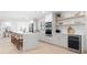 Contemporary kitchen featuring white cabinets, a wine fridge, and stylish open shelving at 2846 Pheasant Run, Clearwater, FL 33759