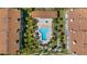 Aerial shot showcasing a pool, manicured landscaping, and surrounding residential buildings at 285 Madeira Cir, Tierra Verde, FL 33715