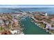 Stunning aerial view of a coastal community with a marina, waterfront homes, and a scenic bridge at 285 Madeira Cir, Tierra Verde, FL 33715