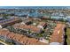 Aerial view of waterfront townhomes with carports, lush landscaping, and convenient parking at 285 Madeira Cir, Tierra Verde, FL 33715