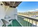 The balcony offers seating and views of the tennis courts and neighborhood at 285 Madeira Cir, Tierra Verde, FL 33715