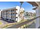 Balcony view of landscaped condominium with a distant waterfront view at 285 Madeira Cir, Tierra Verde, FL 33715