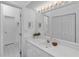 Well-lit bathroom with a large mirror, vanity, and ample cabinet space at 285 Madeira Cir, Tierra Verde, FL 33715