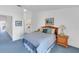 Spacious bedroom features serene blue carpet, queen bed, and wood furniture at 285 Madeira Cir, Tierra Verde, FL 33715