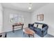 Bright bedroom with a sitting area, window shutters, and a ceiling fan at 285 Madeira Cir, Tierra Verde, FL 33715