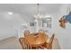 Bright dining space with a wooden table and views into the kitchen at 285 Madeira Cir, Tierra Verde, FL 33715