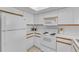 The kitchen features white appliances and plenty of counter space at 285 Madeira Cir, Tierra Verde, FL 33715
