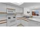 Bright kitchen features white appliances, tile floor, and ample counter space at 285 Madeira Cir, Tierra Verde, FL 33715
