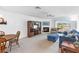 Cozy living room with fireplace, sliding glass doors to the balcony, and comfortable seating at 285 Madeira Cir, Tierra Verde, FL 33715