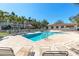 Inviting community pool and lounge area surrounded by tropical landscaping at 285 Madeira Cir, Tierra Verde, FL 33715