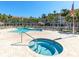 Community pool and hot tub with surrounding condos and palm trees at 285 Madeira Cir, Tierra Verde, FL 33715