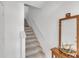 Bright staircase with carpeted steps, white walls, and a small table with decor at 285 Madeira Cir, Tierra Verde, FL 33715
