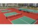 Well-maintained tennis and pickleball courts with green and red surfaces at 285 Madeira Cir, Tierra Verde, FL 33715