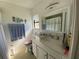 Bathroom featuring a vanity with a granite countertop, toilet, and a framed mirror at 3002 Vivienda Dr # 22, Bradenton, FL 34207
