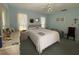 Serene bedroom with light blue walls, two windows and a comfortable bed at 3002 Vivienda Dr # 22, Bradenton, FL 34207