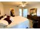 Bright bedroom featuring a ceiling fan, an ensuite bathroom, walk-in closet and a comfortable chair at 3002 Vivienda Dr # 22, Bradenton, FL 34207