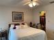 Light bedroom with a ceiling fan, classic furnishings, and a doorway to the en suite bath at 3002 Vivienda Dr # 22, Bradenton, FL 34207