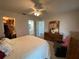 Bright bedroom featuring a ceiling fan, an ensuite bathroom, walk-in closet and a comfortable chair at 3002 Vivienda Dr # 22, Bradenton, FL 34207