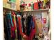Walk-in closet, fully stocked with a variety of clothing items, boxes, and holiday decorations at 3002 Vivienda Dr # 22, Bradenton, FL 34207