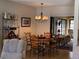 Elegant dining room with wooden table and chairs, lit by a decorative chandelier, perfect for Gathering gatherings at 3002 Vivienda Dr # 22, Bradenton, FL 34207
