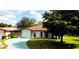 Charming single-story home with a well-manicured front lawn and a beautiful, mature shade tree at 3002 Vivienda Dr # 22, Bradenton, FL 34207