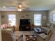 Bright living space featuring comfortable seating, large windows, and a ceiling fan for added comfort at 3002 Vivienda Dr # 22, Bradenton, FL 34207