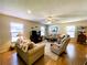 Spacious living room featuring neutral tones, comfortable seating, and ample natural light through the windows at 3002 Vivienda Dr # 22, Bradenton, FL 34207