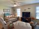Cozy living room featuring comfortable seating, large TV, and bright natural light through the windows at 3002 Vivienda Dr # 22, Bradenton, FL 34207