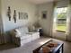 Cozy living room with a sofa, decorative wall sconces, neutral carpet and a coffee table with decor at 3002 Vivienda Dr # 22, Bradenton, FL 34207