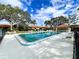 Community pool surrounded by lush greenery, offering a refreshing escape on a sunny day at 3002 Vivienda Dr # 22, Bradenton, FL 34207